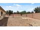 View of the expansive backyard with low-maintenance desert landscaping and secured perimeter fencing at 13438 N 130Th Ln, El Mirage, AZ 85335