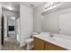 Bright bathroom featuring a white vanity with wood cabinets and a mirror above the sink at 13438 N 130Th Ln, El Mirage, AZ 85335