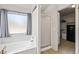 Bright bathroom features a large tub and separate glass shower, with a view to closet at 13438 N 130Th Ln, El Mirage, AZ 85335