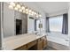 Bathroom with a large vanity, big mirror, and large soaking tub by the windows at 13438 N 130Th Ln, El Mirage, AZ 85335