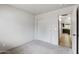 Bedroom with neutral colored carpet, white walls, and view of kitchen at 13438 N 130Th Ln, El Mirage, AZ 85335