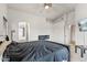 Bedroom features a bed, electric fireplace, and access to the bathroom at 13438 N 130Th Ln, El Mirage, AZ 85335