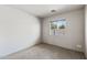 Neutral toned bedroom with carpeted flooring, base molding, and bright windows at 13438 N 130Th Ln, El Mirage, AZ 85335
