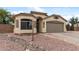 Charming single-story home with a two-car garage and well-maintained front yard with desert landscaping at 13438 N 130Th Ln, El Mirage, AZ 85335