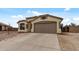 Charming single-story home with a two-car garage and low-maintenance desert landscaping in the front yard at 13438 N 130Th Ln, El Mirage, AZ 85335