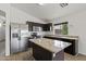 Bright kitchen boasts stainless steel appliances, granite counters, and a center island at 13438 N 130Th Ln, El Mirage, AZ 85335
