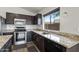Kitchen with stainless steel appliances, granite countertops, and dark cabinetry at 13438 N 130Th Ln, El Mirage, AZ 85335