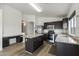 Open kitchen features stainless steel appliances, granite counters, and center island at 13438 N 130Th Ln, El Mirage, AZ 85335