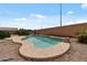 Inviting backyard pool, surrounded by gravel, and a privacy wall with some greenery at 13438 N 130Th Ln, El Mirage, AZ 85335