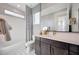 Bathroom featuring a bathtub and shower combo with modern fixtures and finishes at 14837 W Honeysuckle Dr, Surprise, AZ 85387