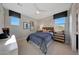 Cozy bedroom with stylish decor, two windows, and warm, inviting colors at 14837 W Honeysuckle Dr, Surprise, AZ 85387
