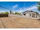 Open backyard space with gravel and dirt landscaping, secured by a combination of wood and white fencing at 1501 E Sheridan St, Phoenix, AZ 85006