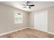 This bedroom features a ceiling fan, wood floors, a window, and a closet at 1501 E Sheridan St, Phoenix, AZ 85006