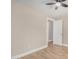 A cozy bedroom with wood-look floors, neutral walls, and a white door at 1501 E Sheridan St, Phoenix, AZ 85006