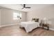 Neutral bedroom with wood-look floors, fan, lamp, and natural light at 1501 E Sheridan St, Phoenix, AZ 85006