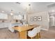 Bright dining area featuring a modern chandelier, wood-look floors, and an open connection to the adjacent kitchen at 1501 E Sheridan St, Phoenix, AZ 85006
