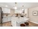 Bright kitchen with white cabinetry, stainless appliances, quartz counters, an island and updated lighting at 1501 E Sheridan St, Phoenix, AZ 85006