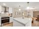 Modern kitchen with a white island, quartz countertops, stainless steel appliances, and decorative lighting at 1501 E Sheridan St, Phoenix, AZ 85006