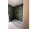 Modern shower featuring gray tiled walls, a rainfall shower head, and a built-in niche at 1501 E Sheridan St, Phoenix, AZ 85006