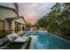 Inviting backyard oasis with a pool, spa, built-in barbecue, and a covered patio with lounge seating at 1529 W State Ave, Phoenix, AZ 85021