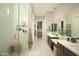 Modern bathroom featuring a glass-enclosed shower, dual sink vanity, and neutral color palette at 1529 W State Ave, Phoenix, AZ 85021