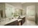 Bright bathroom with double sink vanity, and a view of a shower and the bed room beyond at 1529 W State Ave, Phoenix, AZ 85021