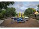 Community playground with various play structures and landscaping, providing a safe and enjoyable space for children at 1529 W State Ave, Phoenix, AZ 85021