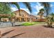 Expansive backyard featuring a covered patio, lush lawn, gravel landscaping, and inviting hot tub at 1565 E Prickly Pear Pl, Casa Grande, AZ 85122