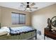 Cozy bedroom with a window, ceiling fan and a twin bed with a patterned quilt at 1565 E Prickly Pear Pl, Casa Grande, AZ 85122