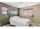 Bedroom with neutral walls and carpet, featuring a wrought iron bed and bedside table at 1565 E Prickly Pear Pl, Casa Grande, AZ 85122