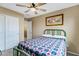 A twin bedroom featuring a ceiling fan, natural light and a bed with a patterned quilt at 1565 E Prickly Pear Pl, Casa Grande, AZ 85122