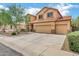 Inviting two-story home with a three-car garage, a red tile roof and easy-care desert landscaping at 1565 E Prickly Pear Pl, Casa Grande, AZ 85122