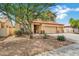 Inviting two-story home with a three-car garage, a red tile roof and easy-care desert landscaping at 1565 E Prickly Pear Pl, Casa Grande, AZ 85122