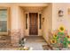 Inviting home entrance featuring stone accents, an entry door, and a decorative sunflower decoration at 1565 E Prickly Pear Pl, Casa Grande, AZ 85122