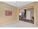 The open concept floor plan features a dining room with neutral paint and gray carpet at 1565 E Prickly Pear Pl, Casa Grande, AZ 85122