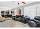 Spacious living room with plush leather seating and an open floorplan leading to the kitchen area at 1565 E Prickly Pear Pl, Casa Grande, AZ 85122