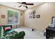 Bright office space with ample natural light, a green leather couch and room for a home office at 1565 E Prickly Pear Pl, Casa Grande, AZ 85122