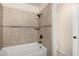 Bright bathroom featuring a bathtub and shower with neutral tile and finishes at 1645 W Baseline Rd # 2098, Mesa, AZ 85202