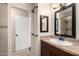 A bathroom with granite counters and wood cabinets with access to the walk-in shower at 1645 W Baseline Rd # 2098, Mesa, AZ 85202
