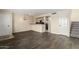 An open-concept room features wood floors, fresh paint, and an interesting light fixture at 1645 W Baseline Rd # 2098, Mesa, AZ 85202