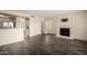 Spacious living room with dark wood floors, a fireplace, and stainless steel appliances at 1645 W Baseline Rd # 2098, Mesa, AZ 85202