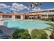 Resort-style swimming pool with lush landscaping, poolside lounge area, and a covered pavilion at 1645 W Baseline Rd # 2098, Mesa, AZ 85202