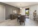 Charming dining room with tile flooring, gray walls, and sliding glass doors to the outdoors at 16514 W Sandia Park Dr, Surprise, AZ 85374