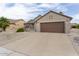 Charming single-story home featuring a two-car garage, a tiled roof, and desert landscaping for low maintenance appeal at 16514 W Sandia Park Dr, Surprise, AZ 85374
