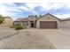 Charming single-story home featuring a well-manicured desert landscape and two-car garage, in a sunny neighborhood at 16514 W Sandia Park Dr, Surprise, AZ 85374