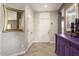 Foyer with bright white door, accented with elegant mirror and decorations at 16514 W Sandia Park Dr, Surprise, AZ 85374
