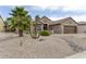 Beautiful home with desert landscaping including palm trees and cacti at 16514 W Sandia Park Dr, Surprise, AZ 85374