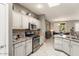 Well-lit kitchen features granite counters, stainless steel appliances, and stylish cabinetry at 16514 W Sandia Park Dr, Surprise, AZ 85374