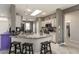 Kitchen features granite countertops, bar seating, white cabinetry, and stainless steel appliances at 16514 W Sandia Park Dr, Surprise, AZ 85374