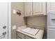 Functional laundry area equipped with sink, cabinets, and convenient storage at 16514 W Sandia Park Dr, Surprise, AZ 85374